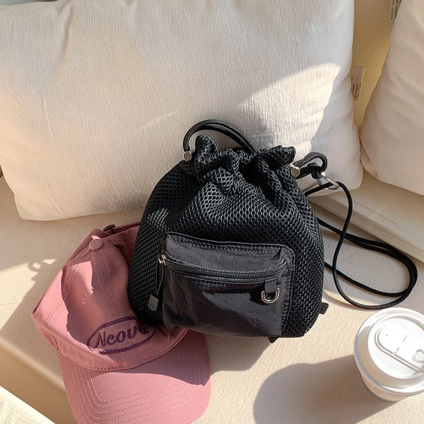 Black small mesh drawstring bucket bag with shoulder strap for summer travel